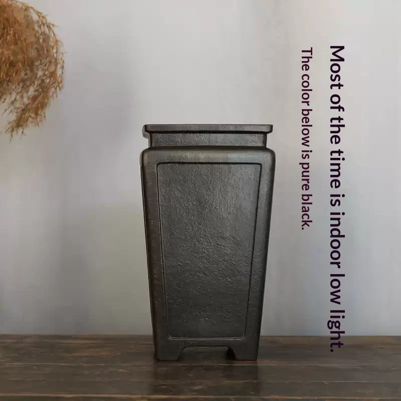 Front view of tall dark square pot with lighting annotation