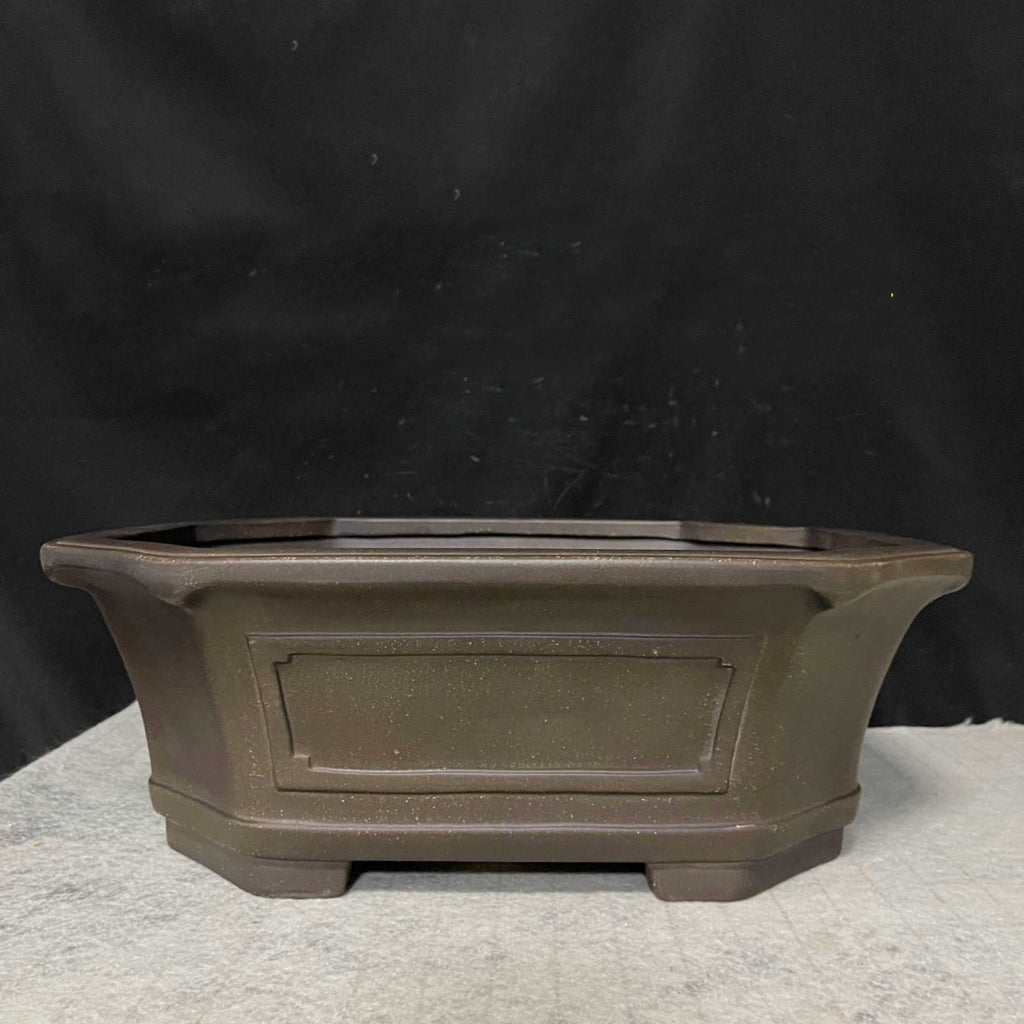 Side profile of dark brown clipped-corner pot with framed panel