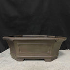Side profile of dark brown clipped-corner pot with framed panel