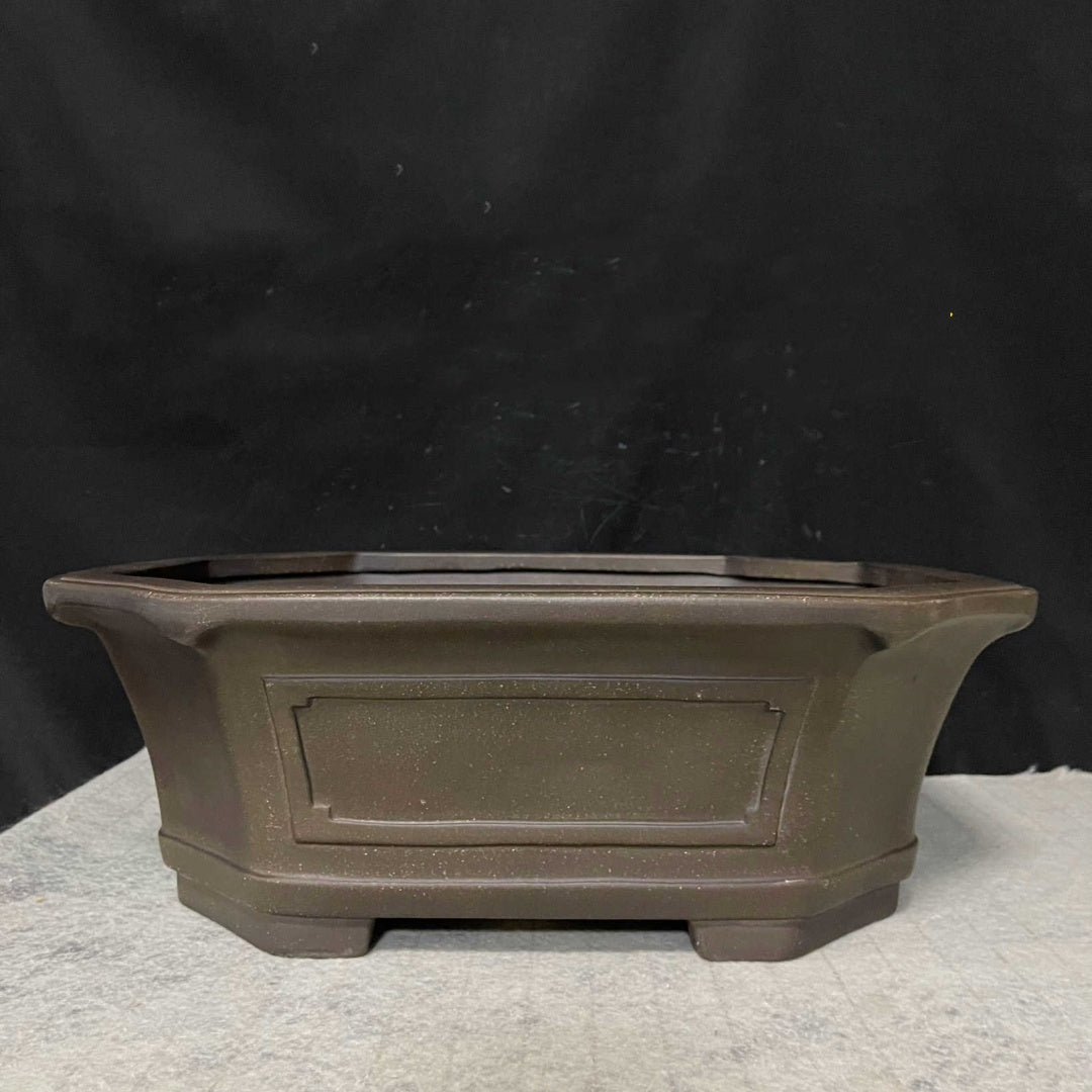 Side profile of dark brown clipped-corner pot with framed panel