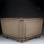 Deep taupe square bonsai pot with framed panels and block feet
