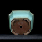 Light-green square pot underside and raised feet