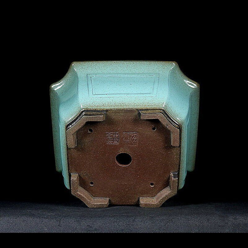 Light-green square pot underside and raised feet