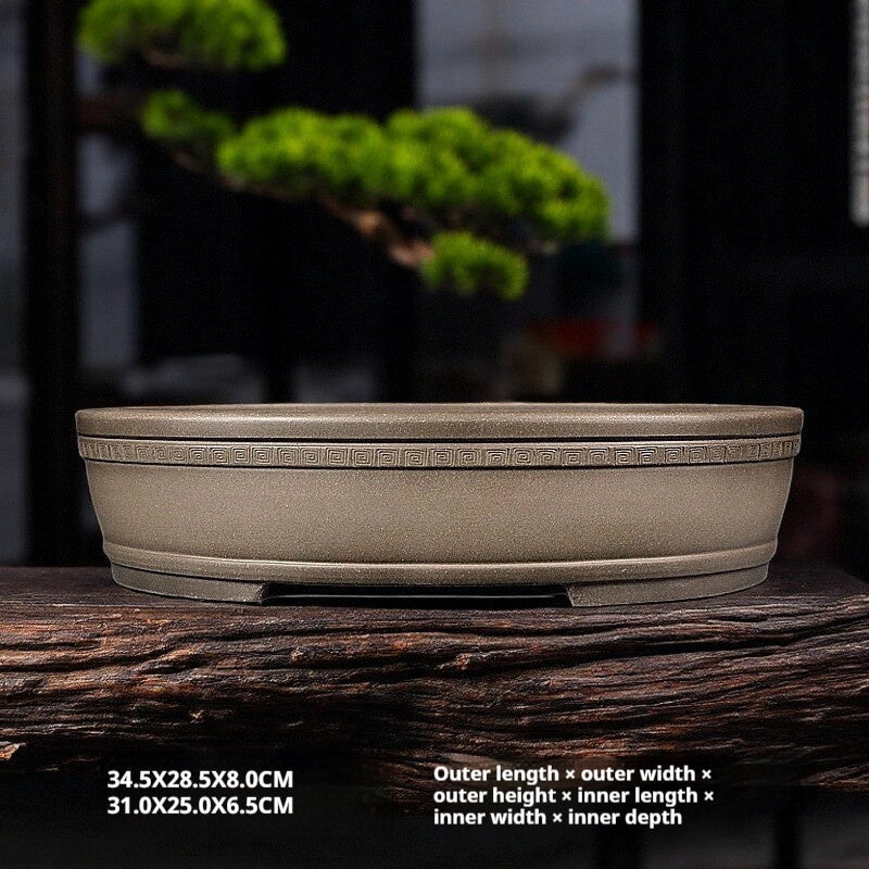 Taupe oval pot on a wooden display surface with printed measurements