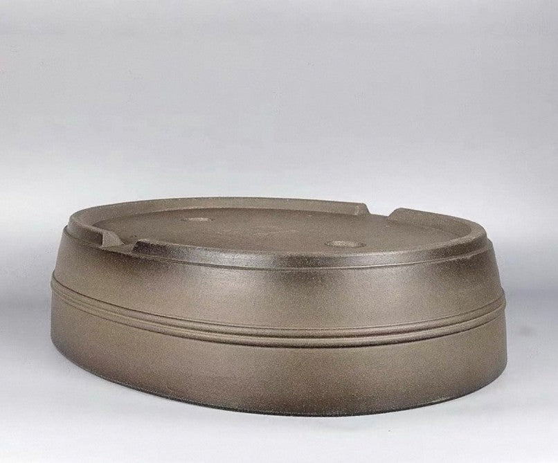 Taupe oval pot upside down showing its banded walls
