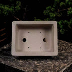 Top view of taupe rectangular pot showing two large openings and four small holes