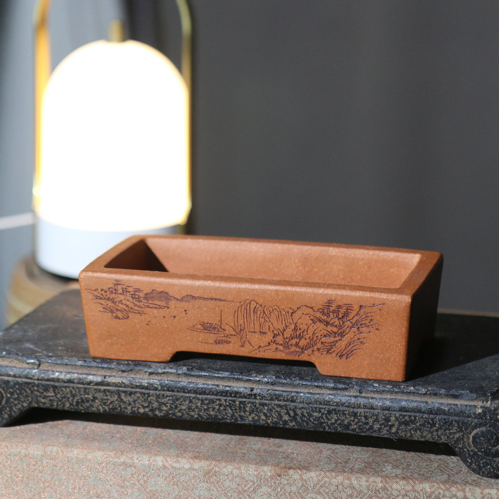 Angled view of the landscape-decorated rectangular pot