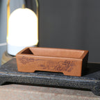 Angled view of the landscape-decorated rectangular pot