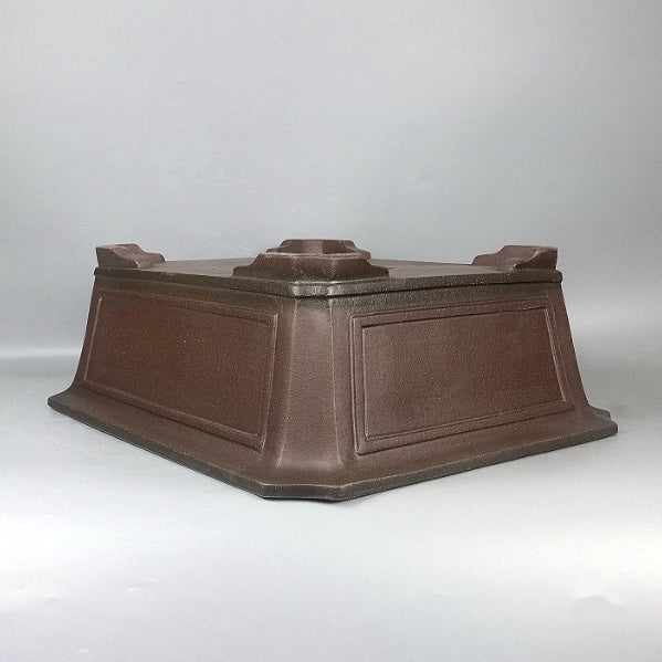 Upside-down brown rectangular pot showing framed sides and corner feet