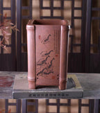 Decorated side of the tall square pot showing shrimp imagery and calligraphy