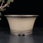 Deep taupe round pot with flaring walls and broad rim