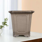 Tall taupe square pot with framed panels and curled feet