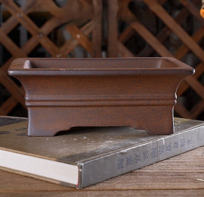 Brown rectangular bonsai pot with flared rim, double band and notched base