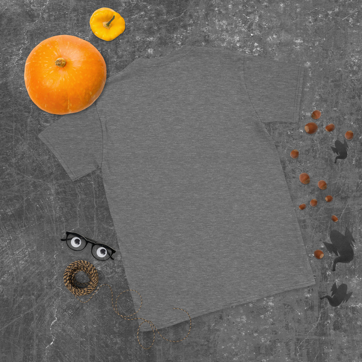 Plain back of heathered dark gray Bonsai Life Co. T-shirt in a gray flat lay with pumpkins