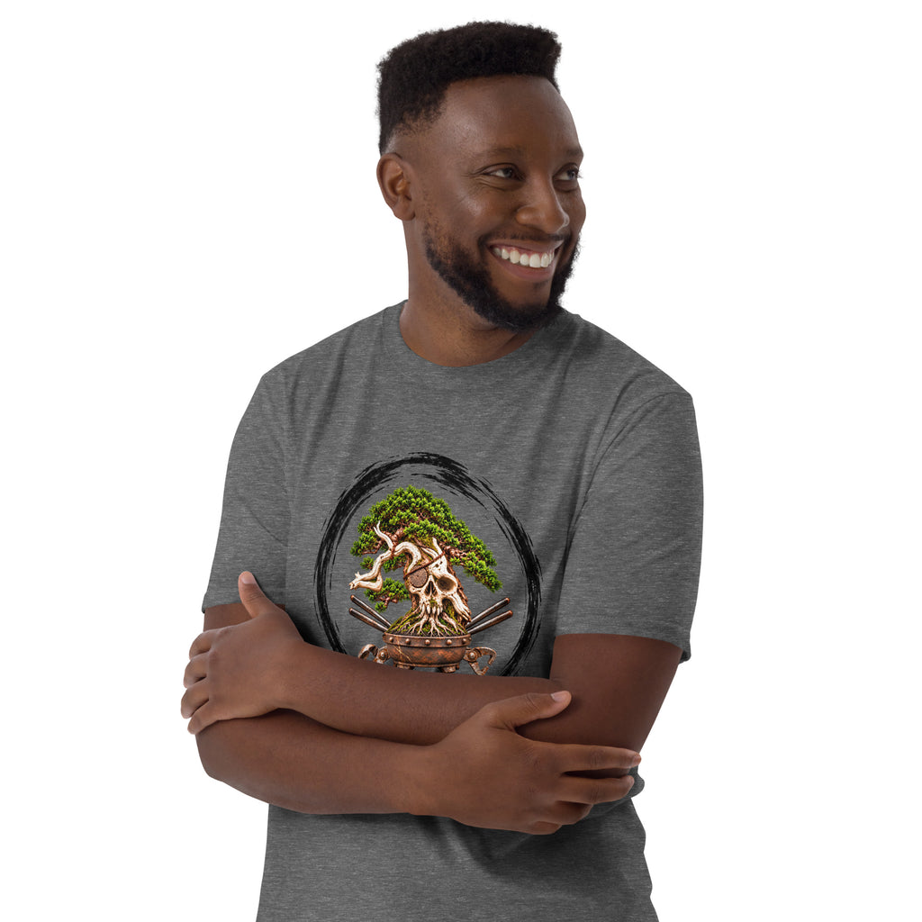 Model wearing heathered dark gray T-shirt with green bonsai and pirate skull graphic inside a black circle with Bonsai Life Co. lettering, arms-crossed close view