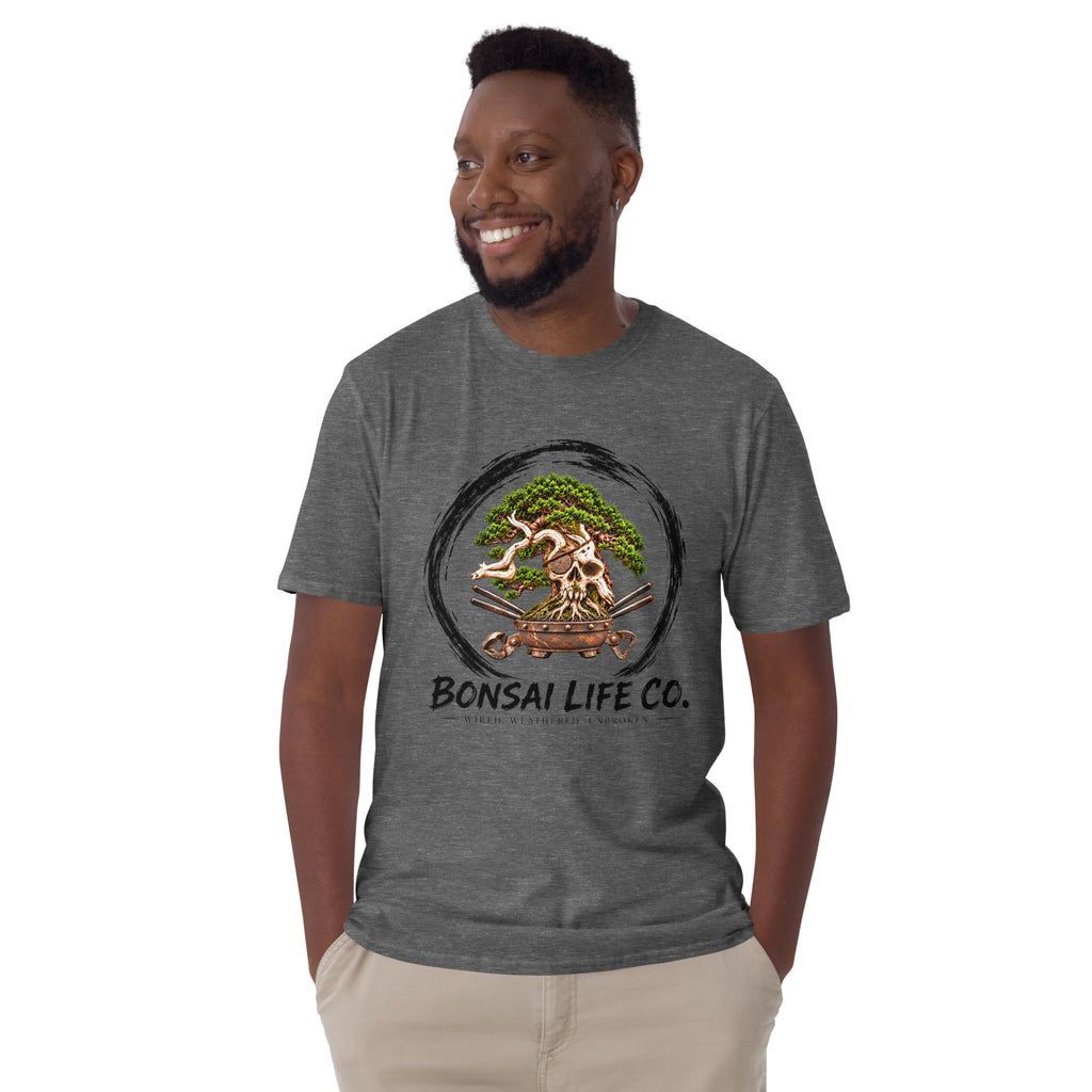 Model wearing heathered dark gray T-shirt with green bonsai and pirate skull graphic inside a black circle with Bonsai Life Co. lettering, front view