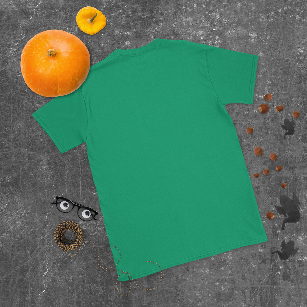 Plain back of bright green Bonsai Life Co. T-shirt in a gray flat lay with pumpkins