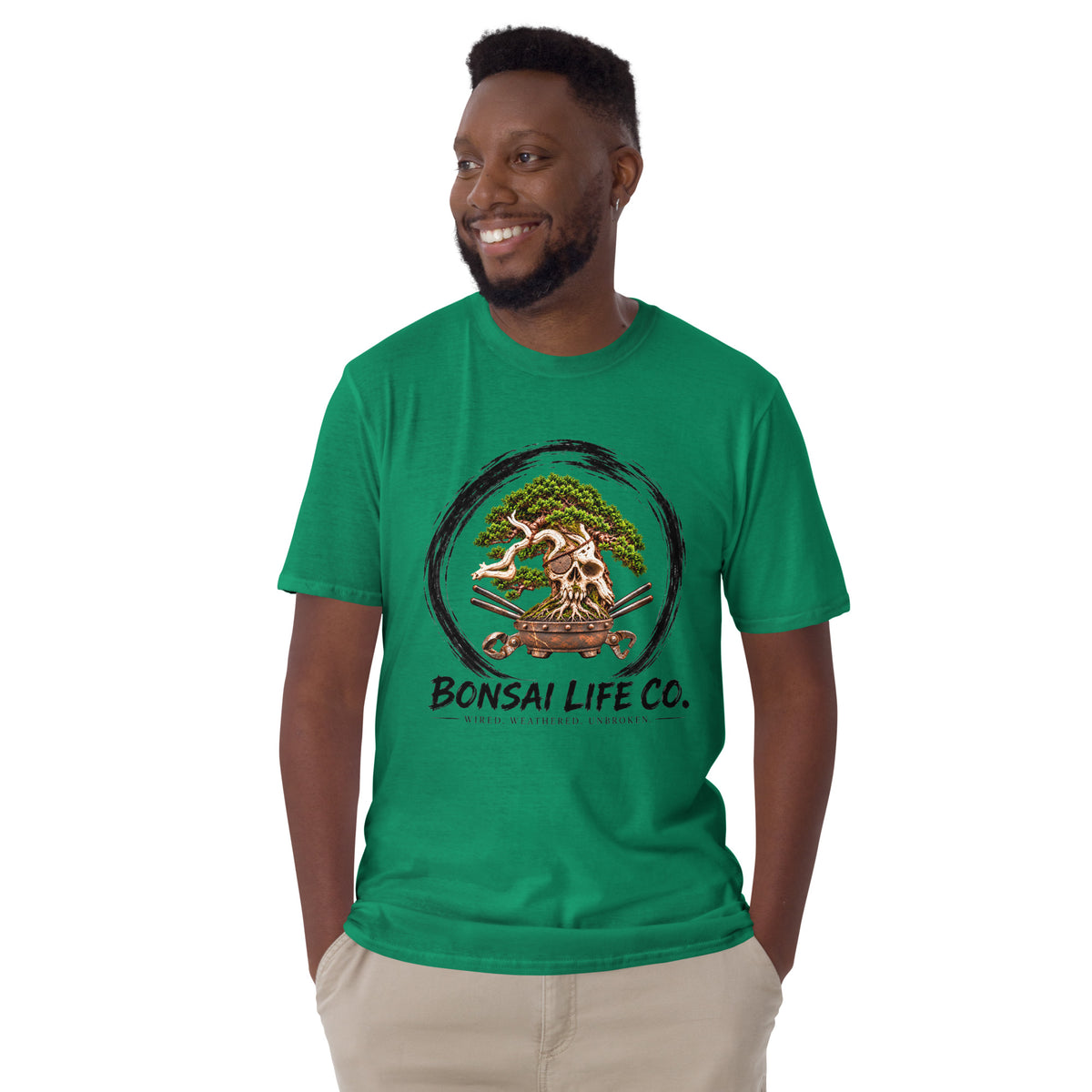Model wearing bright green T-shirt with green bonsai and pirate skull graphic inside a black circle with Bonsai Life Co. lettering, front view