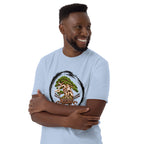 Model wearing light blue T-shirt with green bonsai and pirate skull graphic inside a black circle with Bonsai Life Co. lettering, arms-crossed close view