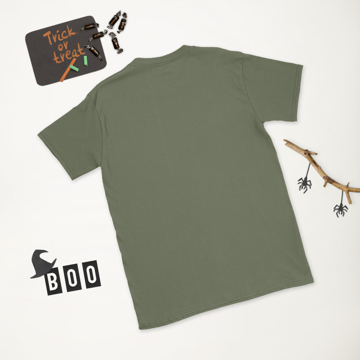 Plain back of muted olive green Bonsai Life Co. T-shirt in a white Halloween flat lay