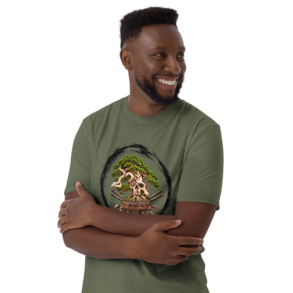 Model wearing muted olive green T-shirt with green bonsai and pirate skull graphic inside a black circle with Bonsai Life Co. lettering, arms-crossed close view