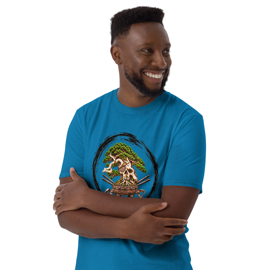 Model wearing sapphire blue T-shirt with green bonsai and pirate skull graphic inside a black circle with Bonsai Life Co. lettering, arms-crossed close view