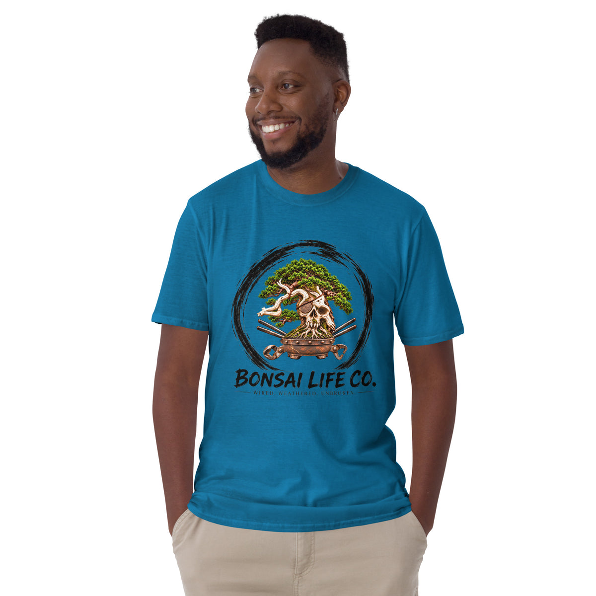 Model wearing sapphire blue T-shirt with green bonsai and pirate skull graphic inside a black circle with Bonsai Life Co. lettering, front view