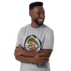 Model wearing heathered light gray T-shirt with green bonsai and pirate skull graphic inside a black circle with Bonsai Life Co. lettering, arms-crossed close view