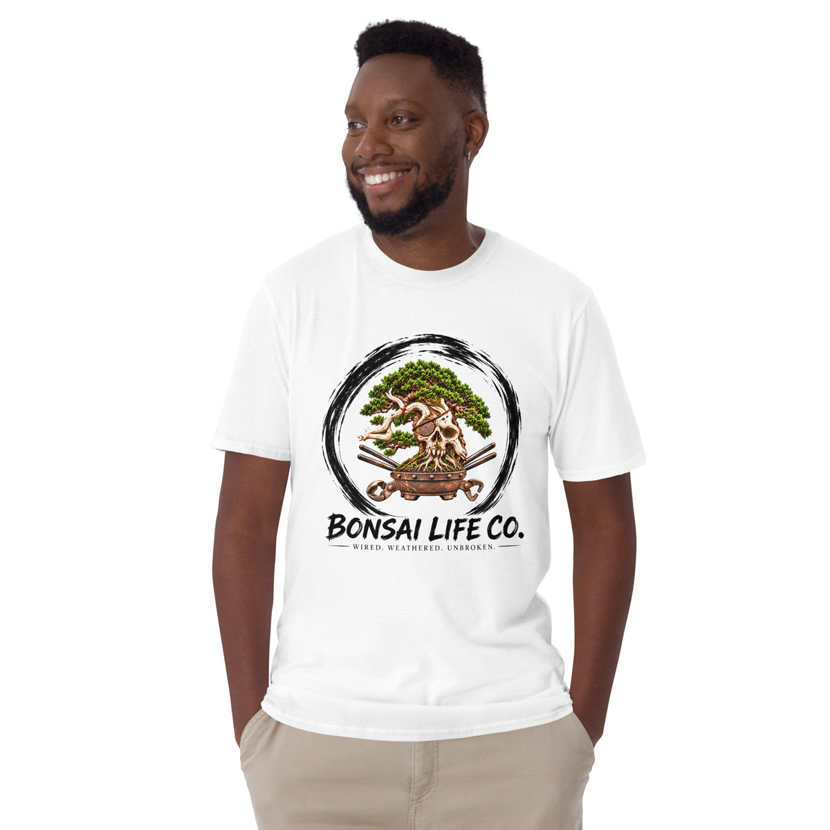 Model wearing white T-shirt with green bonsai and pirate skull graphic inside a black circle with Bonsai Life Co. lettering, front view