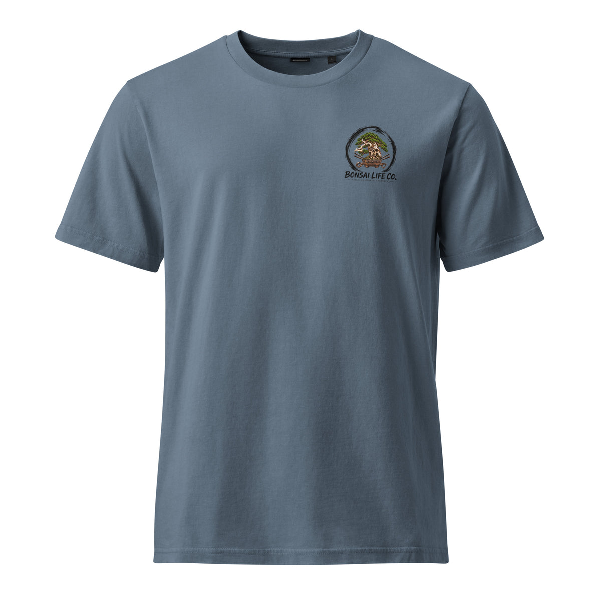 Front of muted blue T-shirt with small circular bonsai pirate skull chest emblem