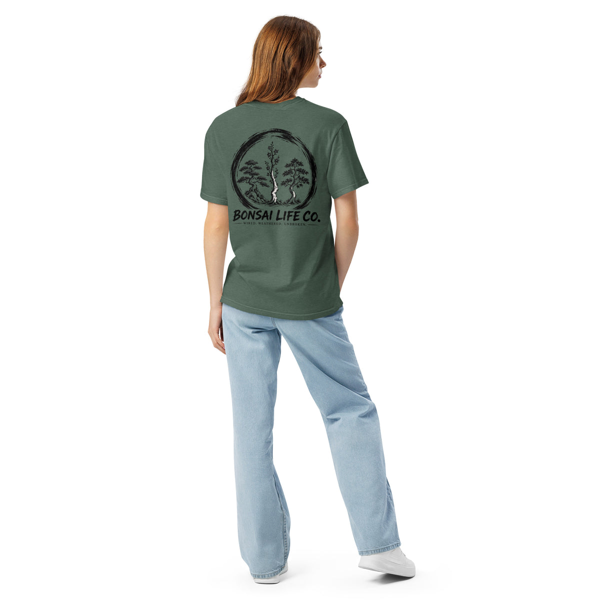 Model showing back of muted blue-green T-shirt with large black Three Trees circle and Bonsai Life Co. lettering
