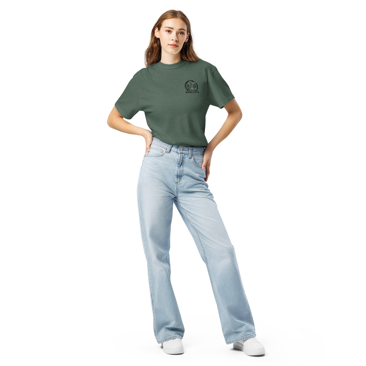 Model wearing muted blue-green T-shirt with small circular Three Trees chest logo, full-length front view