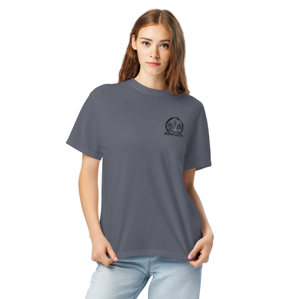 Model wearing slate blue T-shirt with small circular Three Trees chest logo, closer front view