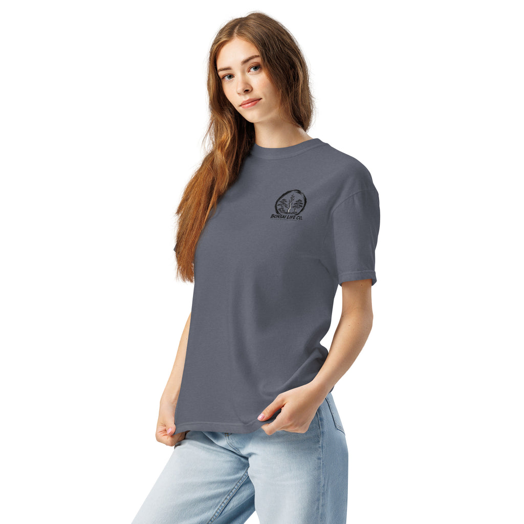 Model wearing slate blue T-shirt with small circular Three Trees chest logo, angled front view
