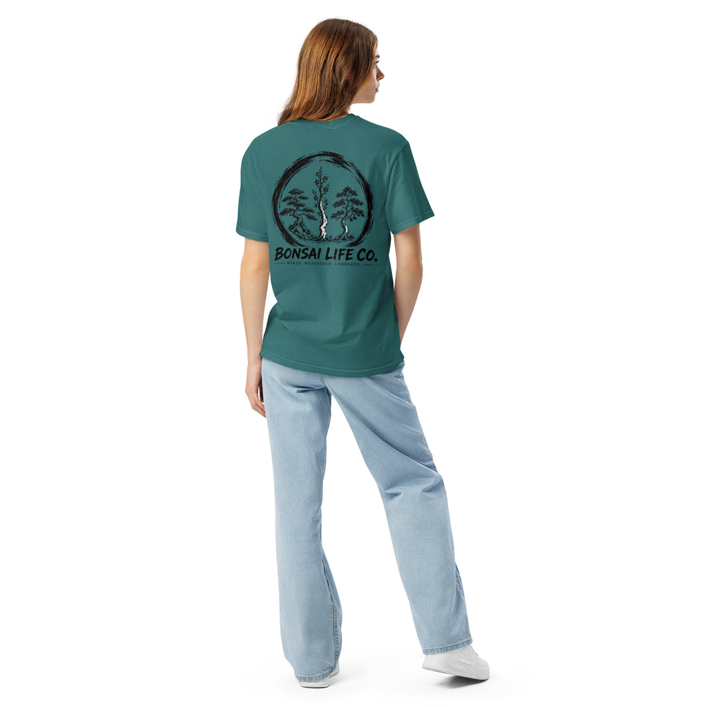Model showing back of teal green T-shirt with large black Three Trees circle and Bonsai Life Co. lettering
