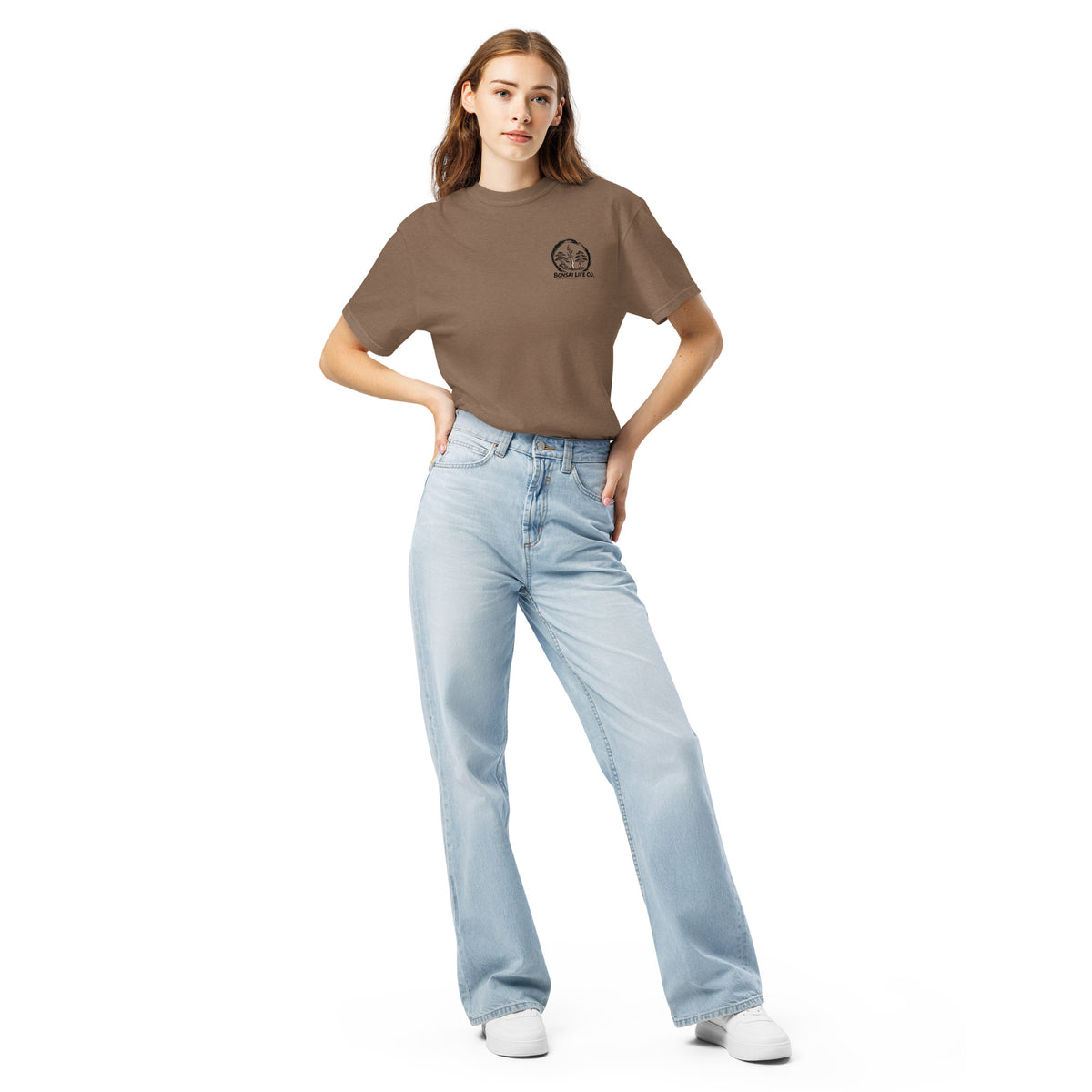 Model wearing brown T-shirt with small circular Three Trees chest logo, full-length front view