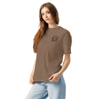 Model wearing brown T-shirt with small circular Three Trees chest logo, angled front view