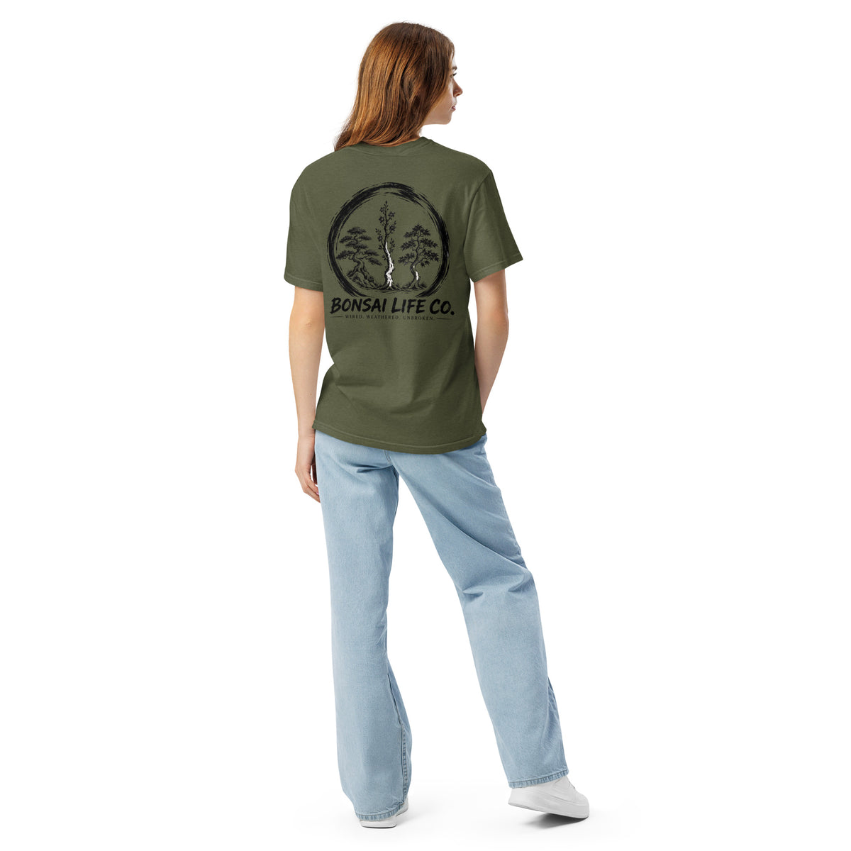 Model showing back of olive green T-shirt with large black Three Trees circle and Bonsai Life Co. lettering
