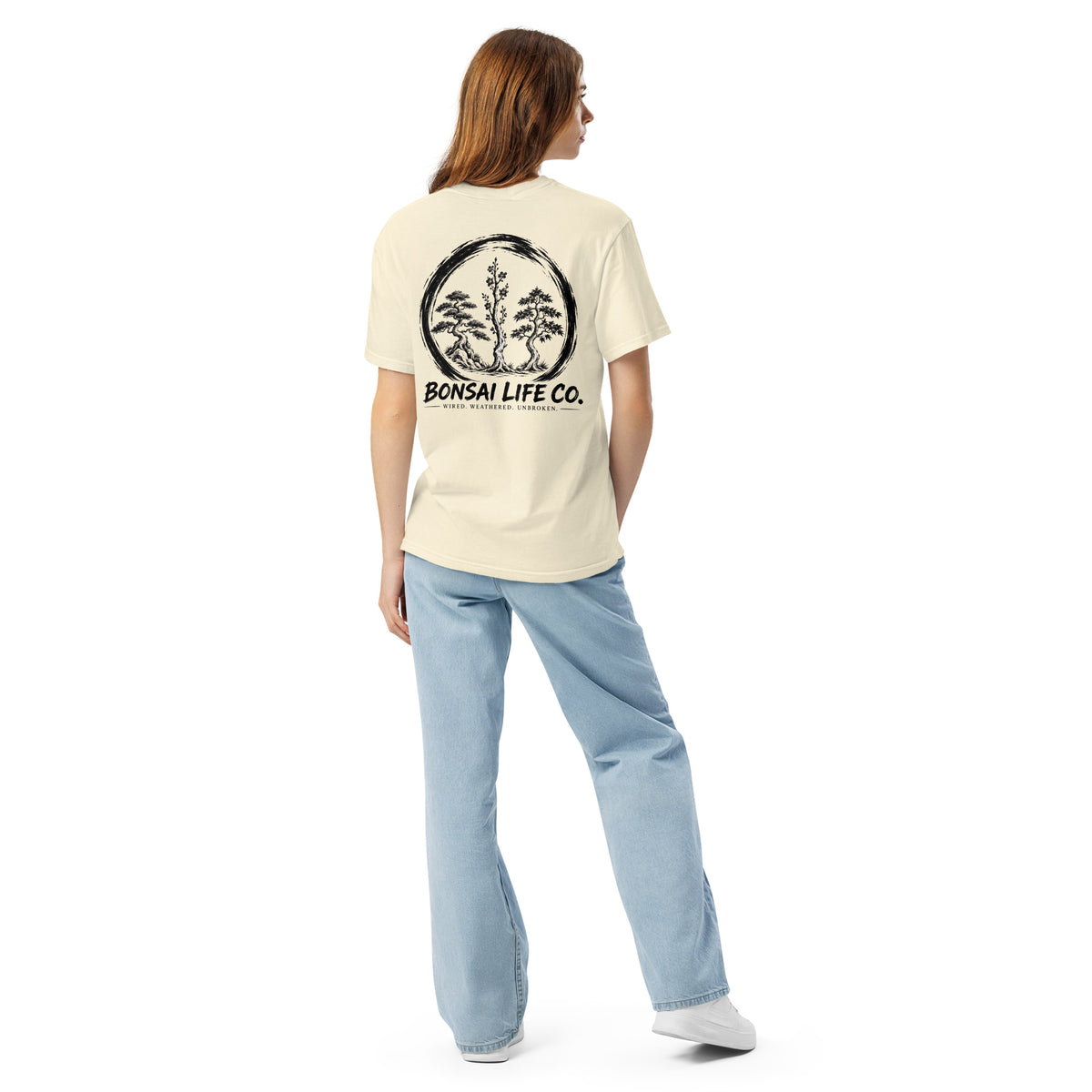 Model showing back of ivory T-shirt with large black Three Trees circle and Bonsai Life Co. lettering