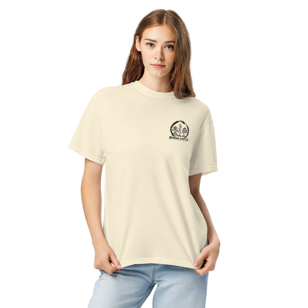 Model wearing ivory T-shirt with small circular Three Trees chest logo, closer front view