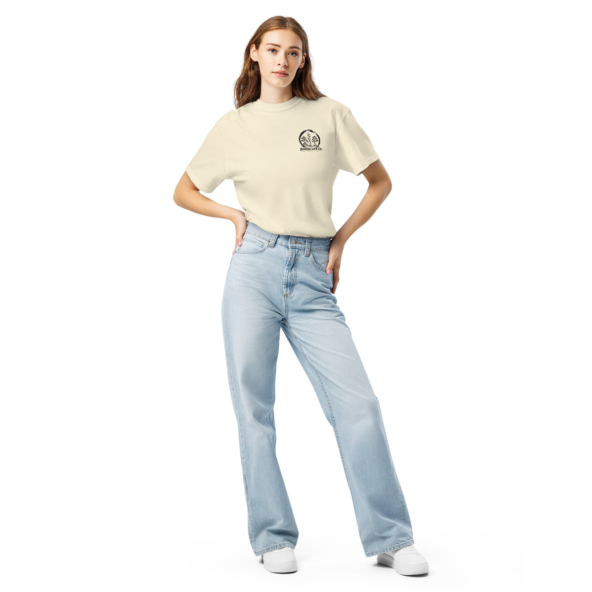 Model wearing ivory T-shirt with small circular Three Trees chest logo, full-length front view