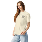 Model wearing ivory T-shirt with small circular Three Trees chest logo, angled front view