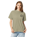 Model wearing khaki beige T-shirt with small circular Three Trees chest logo, closer front view