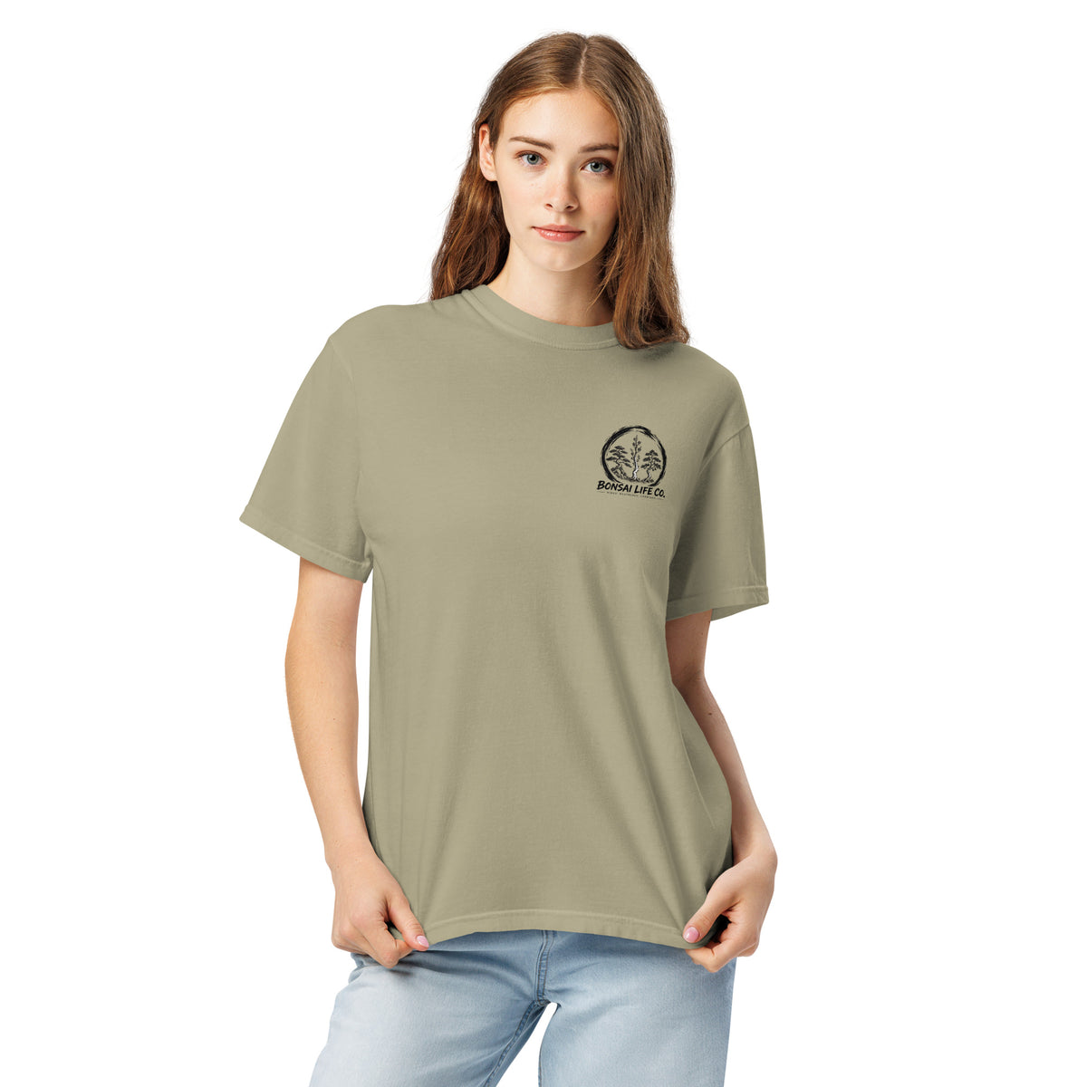 Model wearing khaki beige T-shirt with small circular Three Trees chest logo, closer front view