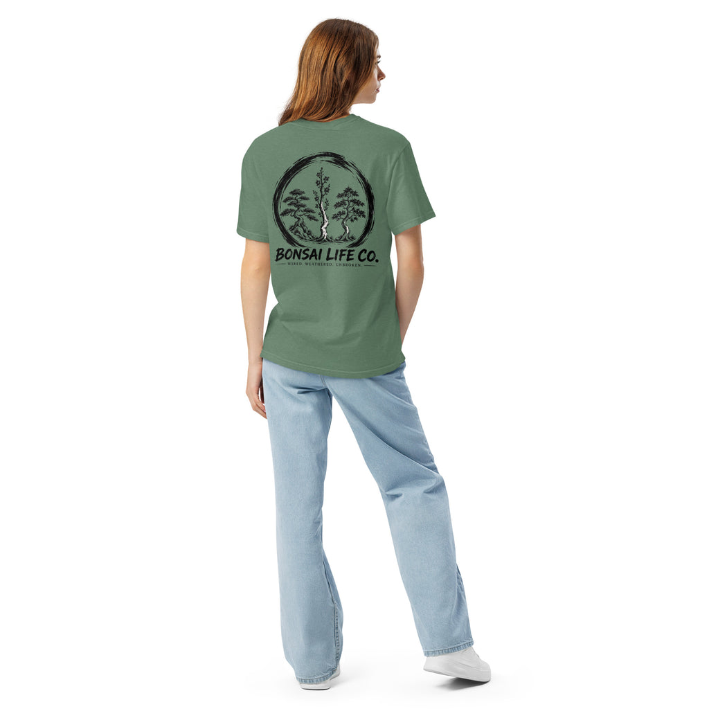 Model showing back of sage green T-shirt with large black Three Trees circle and Bonsai Life Co. lettering