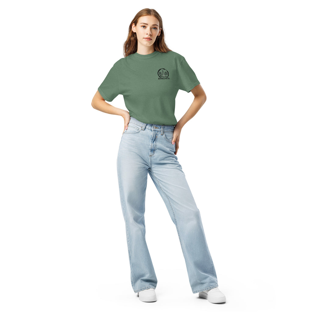 Model wearing sage green T-shirt with small circular Three Trees chest logo, full-length front view