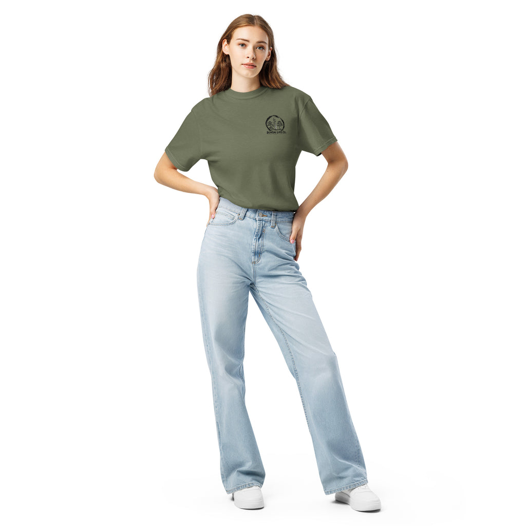 Model wearing moss green T-shirt with small circular Three Trees chest logo, full-length front view