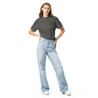 Model wearing washed charcoal gray T-shirt with small circular Three Trees chest logo, full-length front view