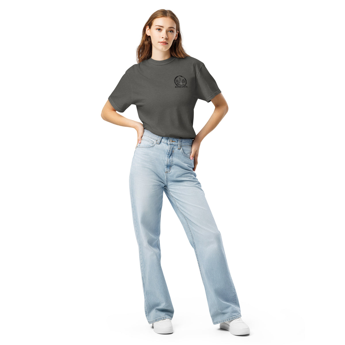 Model wearing washed charcoal gray T-shirt with small circular Three Trees chest logo, full-length front view