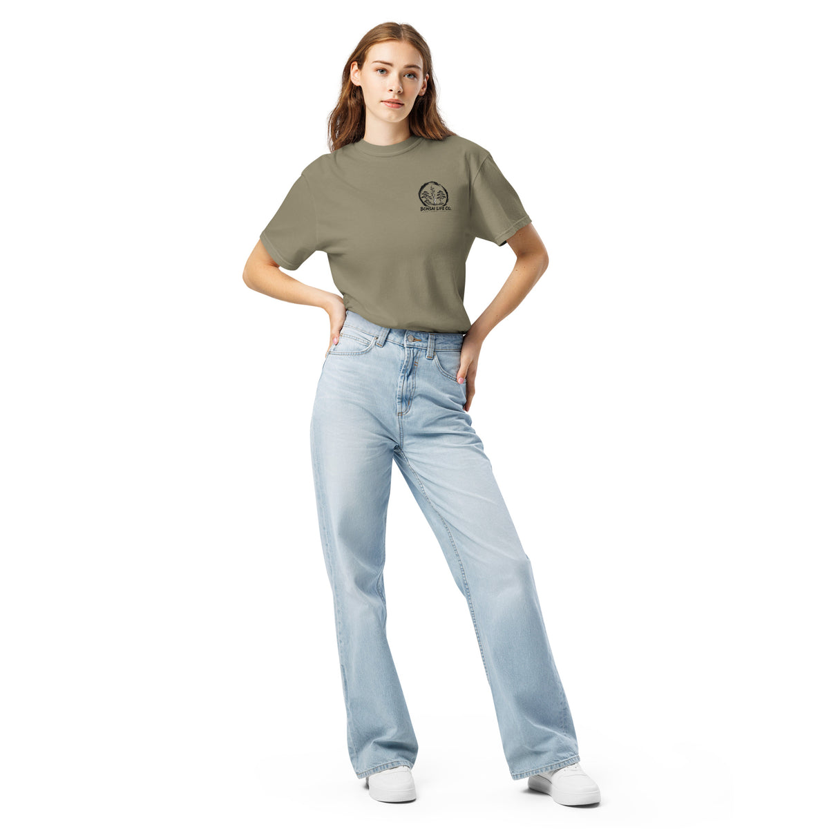 Model wearing gray-beige T-shirt with small circular Three Trees chest logo, full-length front view